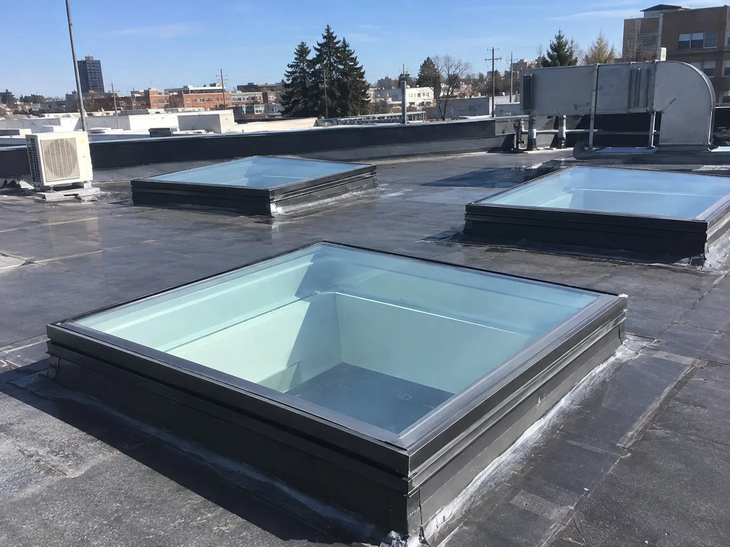 Roofing contractors working on a residential roof in West Auckland