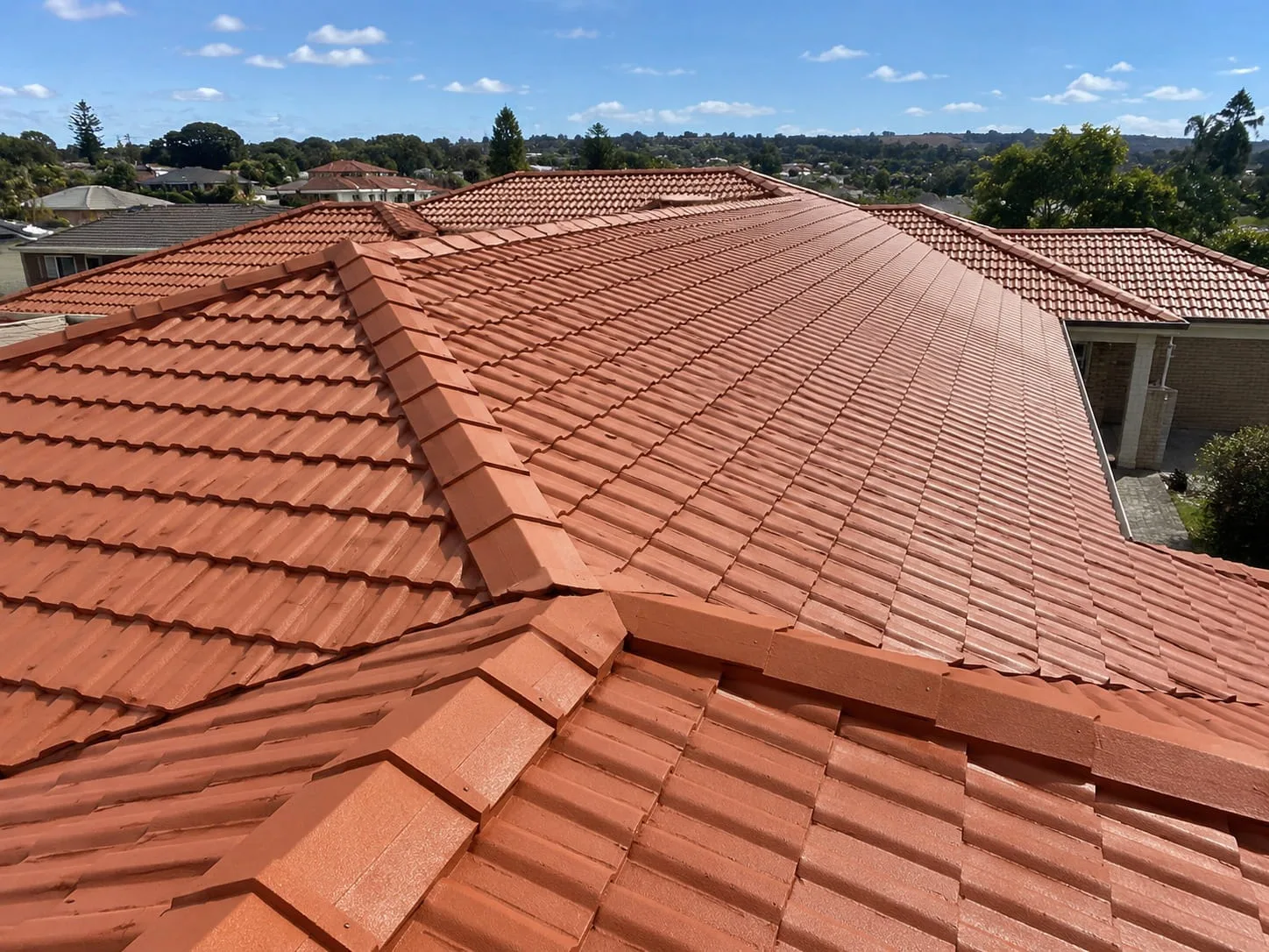 Tile roof repair being carried out on a West Auckland home